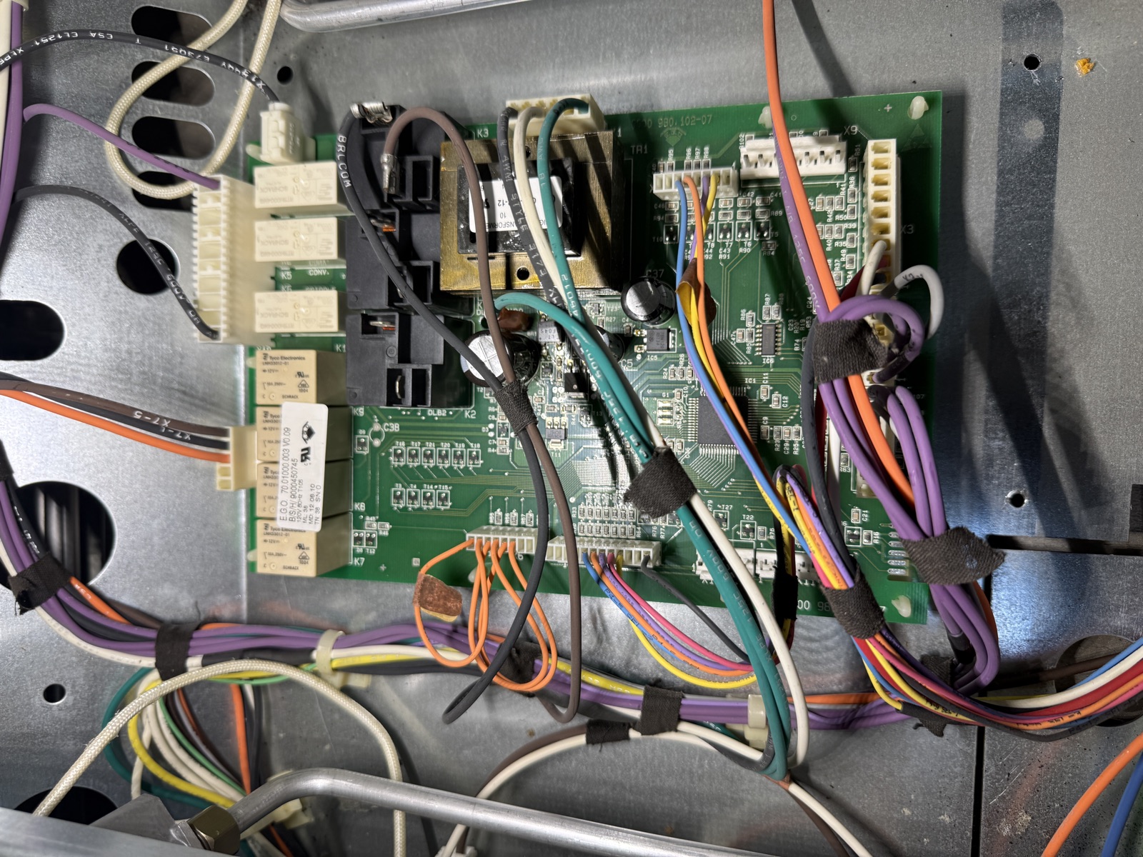 Control board mounted inside the Thermador range with wiring harnesses connected