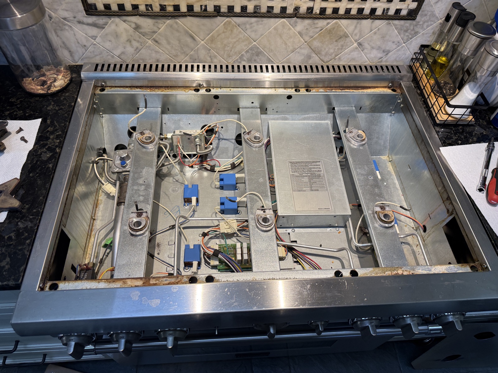 Thermador range with the cooktop removed, showing the wiring and components underneath