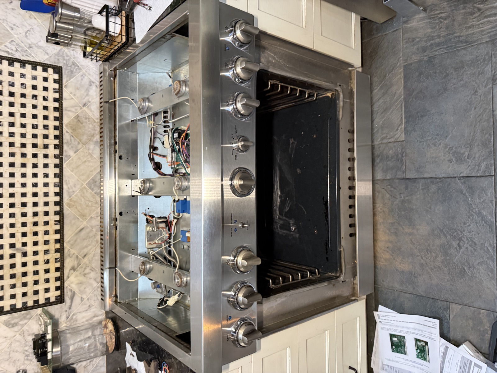 Thermador range with the top opened up and the oven door off during the repair