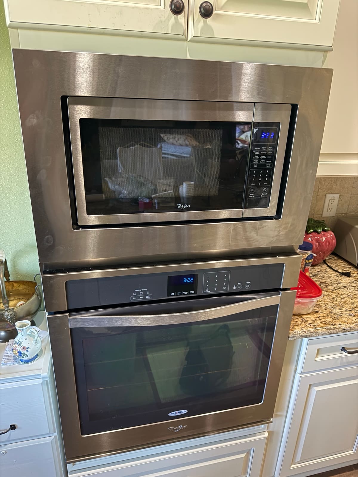 Whirlpool built-in microwave in a trim kit stacked above a Whirlpool wall oven in an East Lake Woodlands, Oldsmar kitchen
