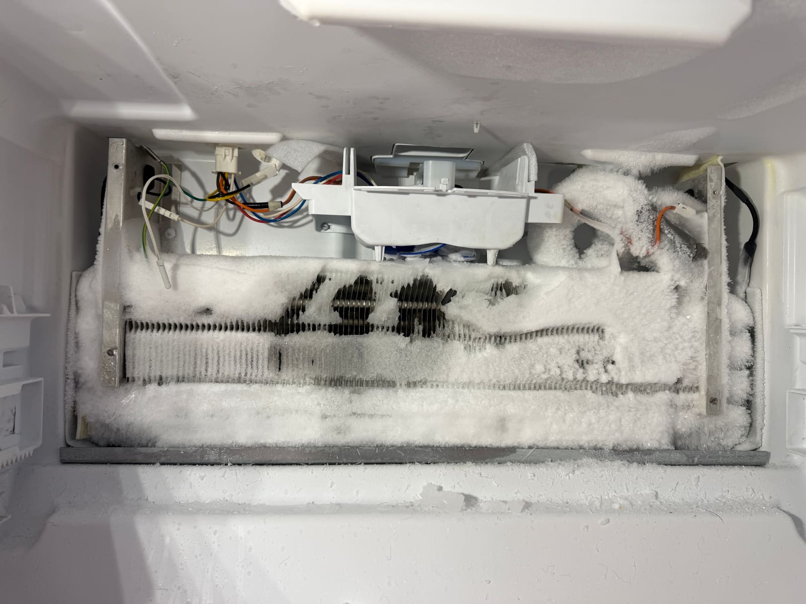 Whirlpool freezer evaporator coil packed with ice up to the fan housing