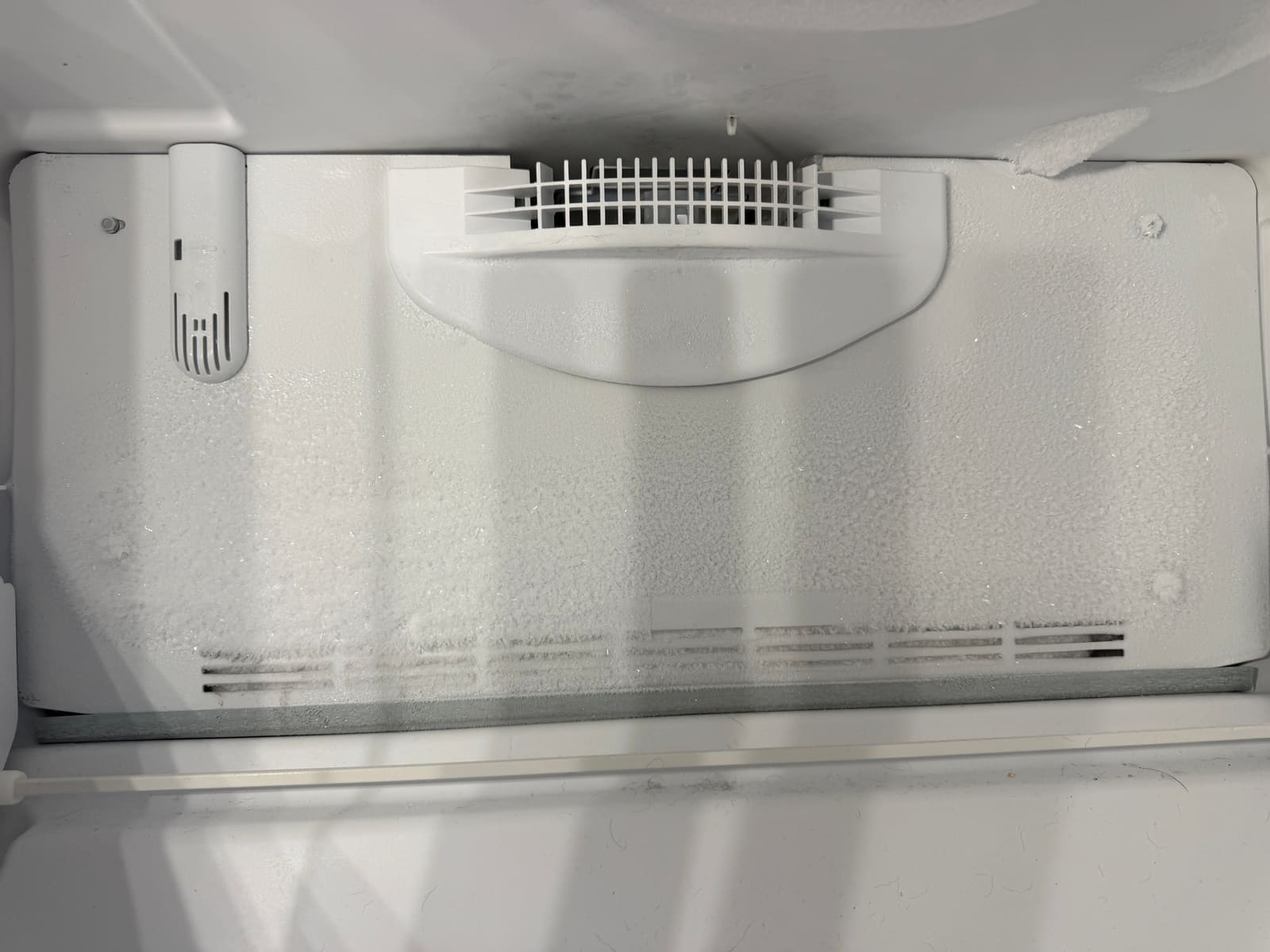 Frost covering the evaporator panel at the back of the Whirlpool bottom freezer