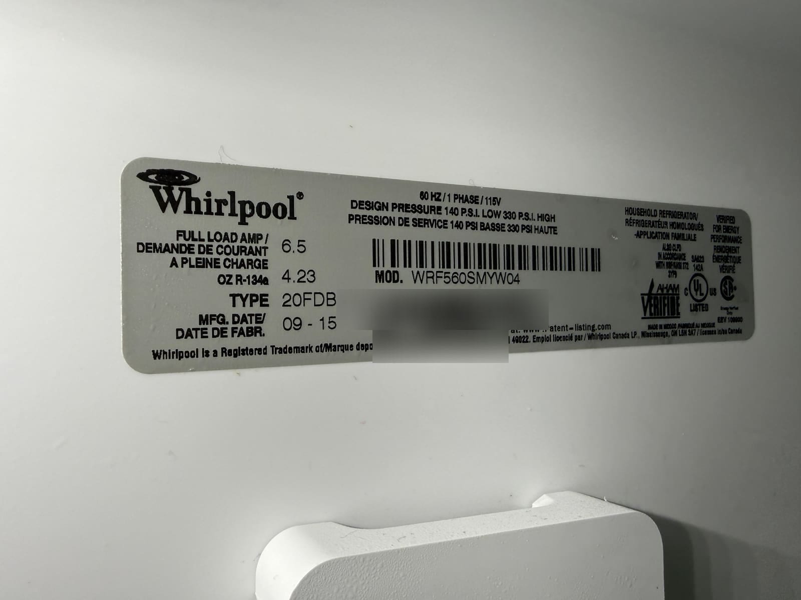 Whirlpool refrigerator data plate showing model WRF560SMYW04, manufactured September 2015