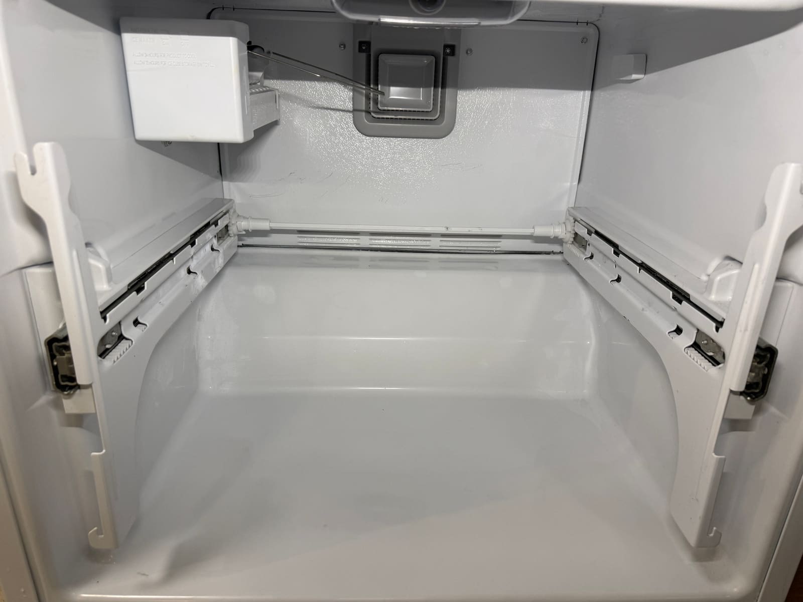 Whirlpool freezer with the back panel put back and the drawer rails clean after the repair