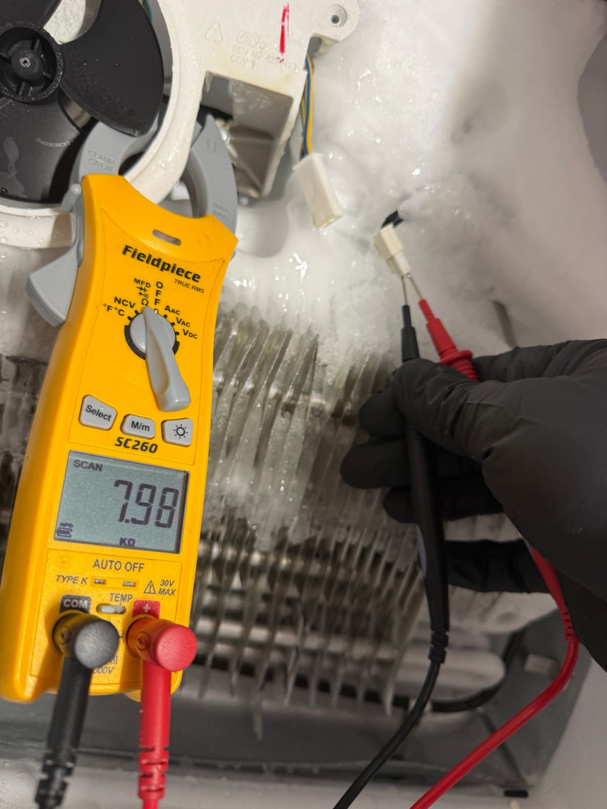 Meter showing about 8 kilohms across the defrost thermistor leads on the iced-over evaporator