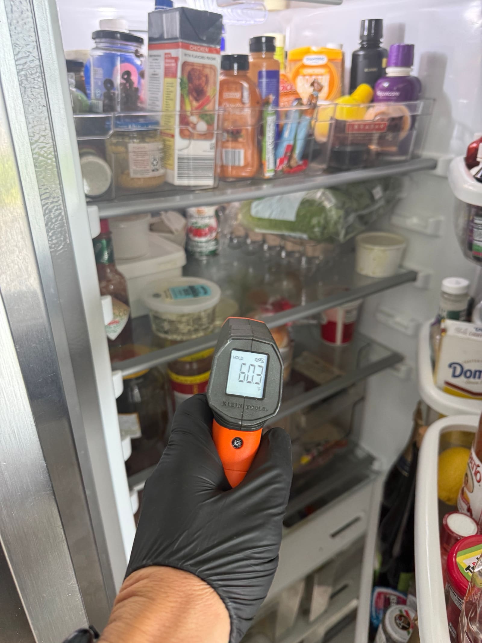 Infrared thermometer reading over 60°F inside the Whirlpool refrigerator compartment