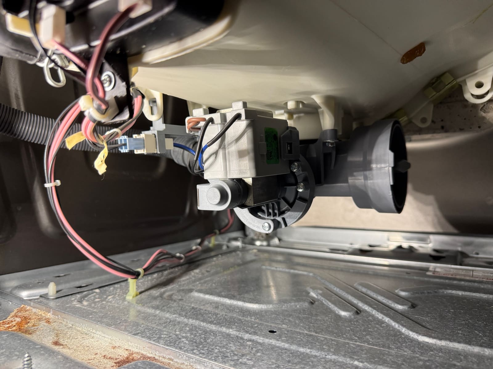 New drain pump installed at the bottom of the Whirlpool Duet washer cabinet