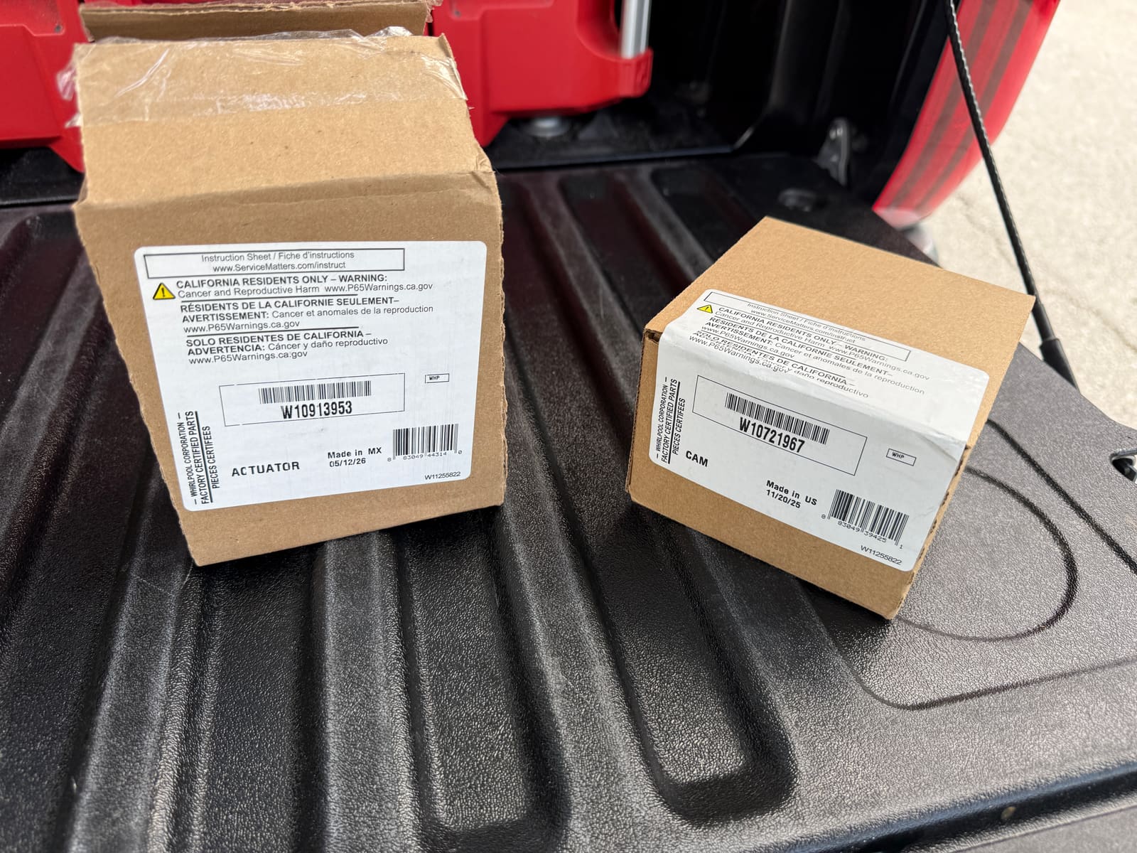 New Whirlpool OEM cam and actuator parts in their boxes