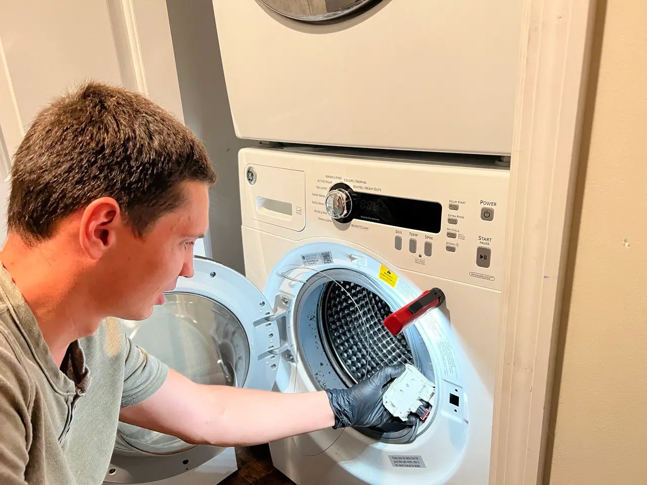 Technician repairing a washer in a Tampa Bay home.