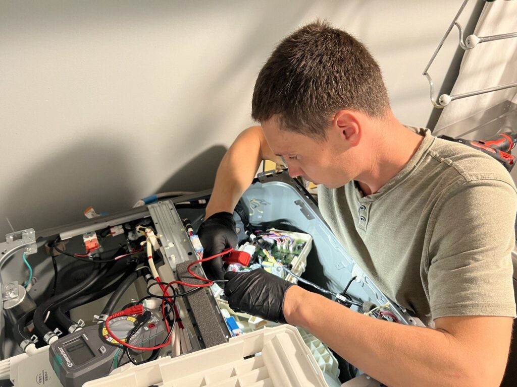 Certified technician repairing an appliance in Clearwater