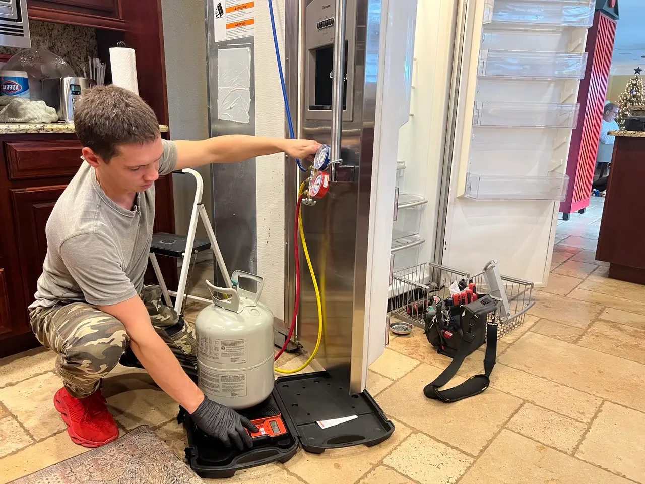 Technician repairing a commercial refrigerator